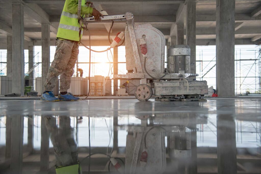 Operator passing the polishing machine on polished cement seulo in mallorca