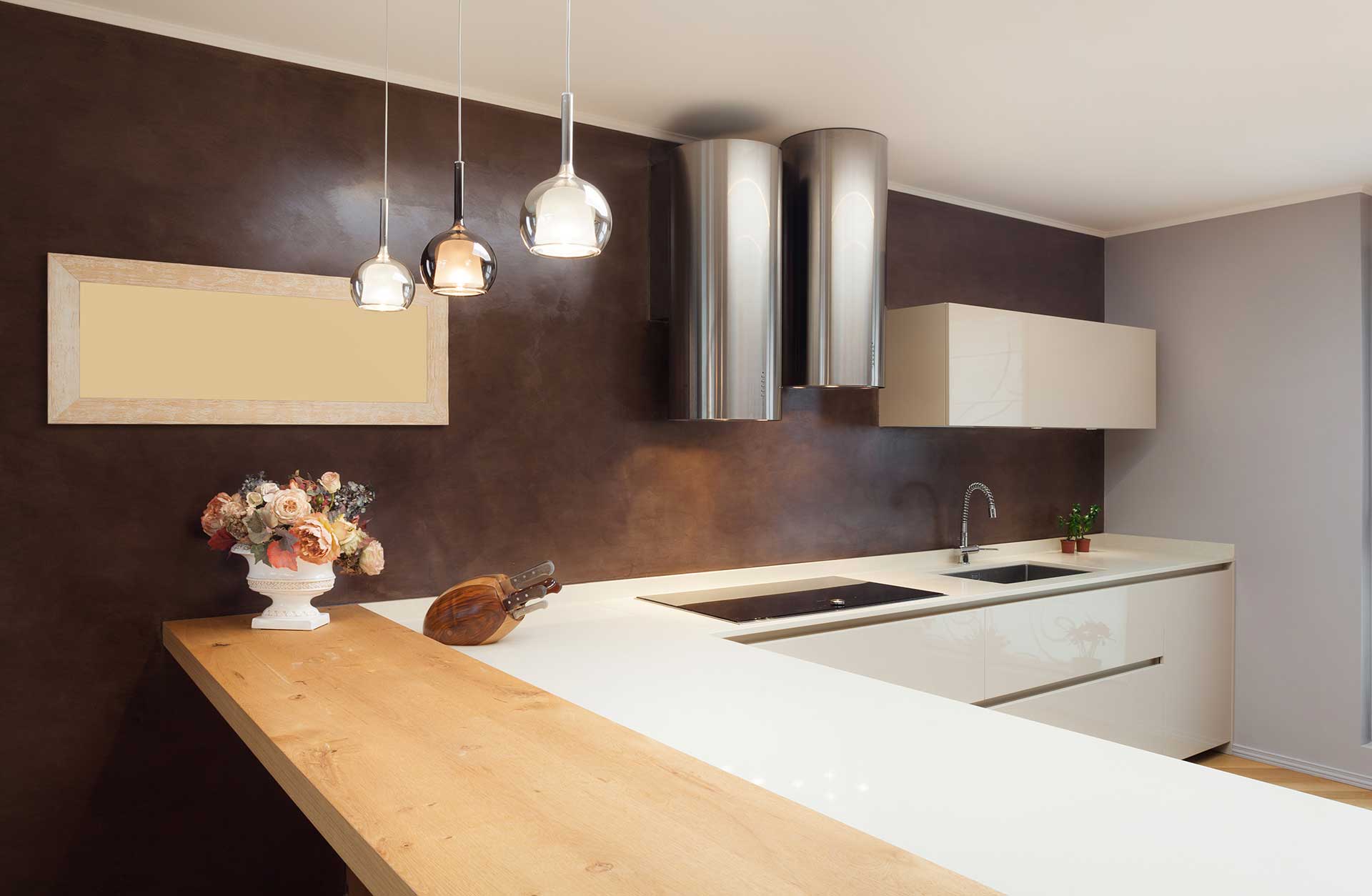 Modern kitchen finished with burgundy microcement walls in Inca. Majorca.